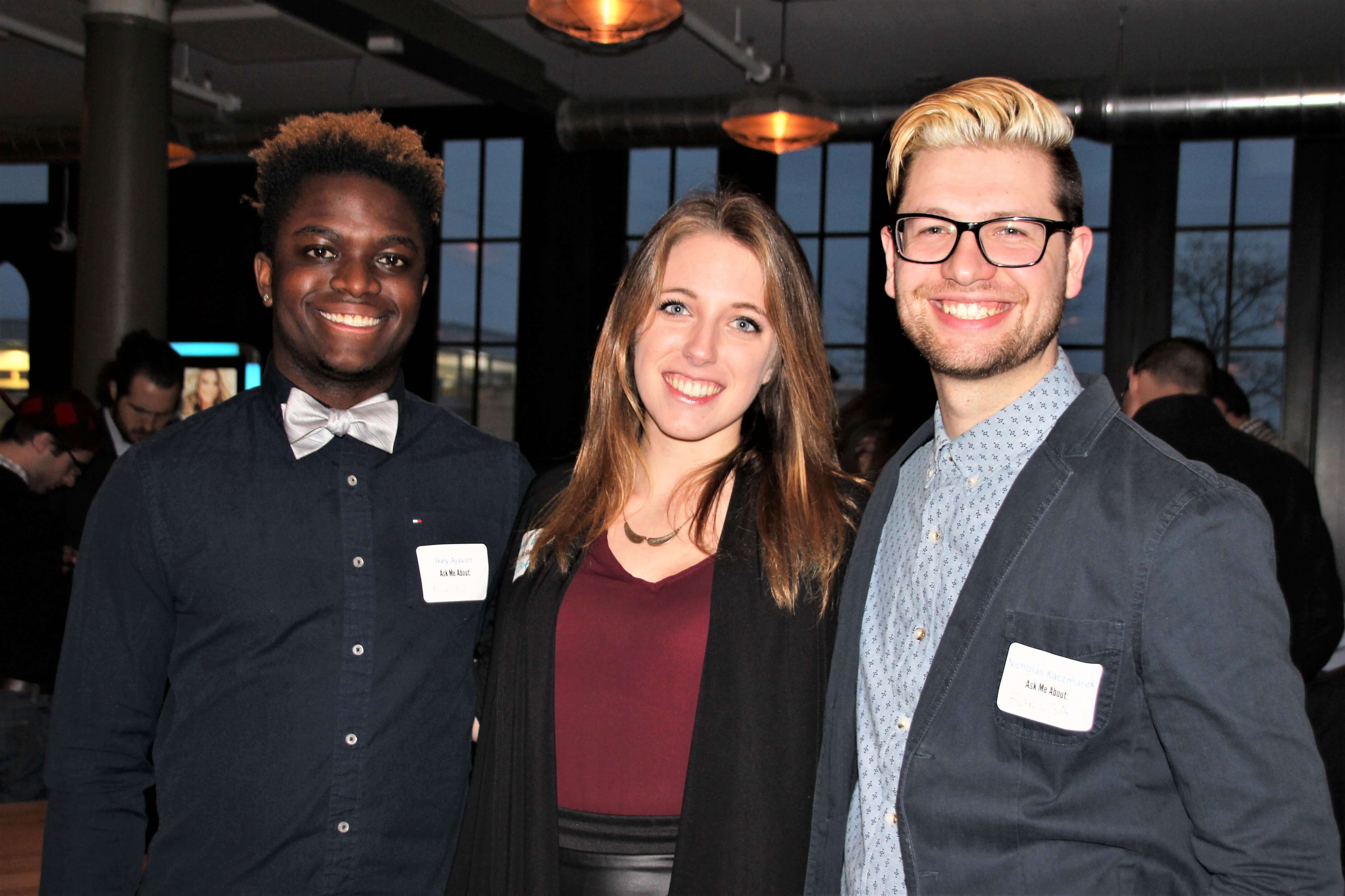 Three young next generation united members at a mixer