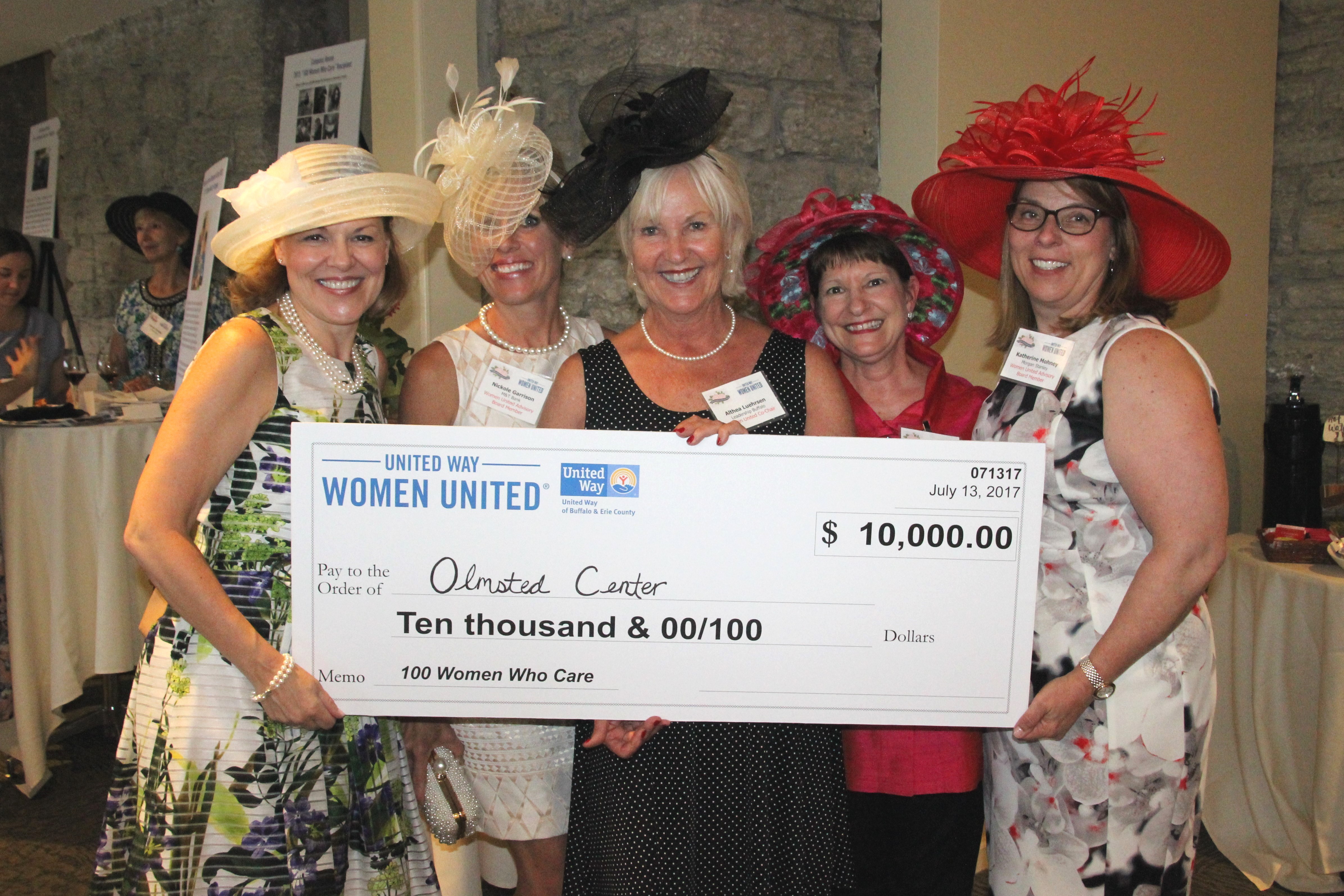Five women united members holding a large donation check for $10,000